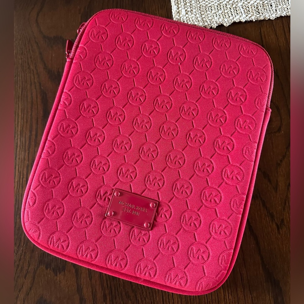 Michael Kors iPad Neoprene Sleeve Red fits iPads with up to 10.9” screens.
